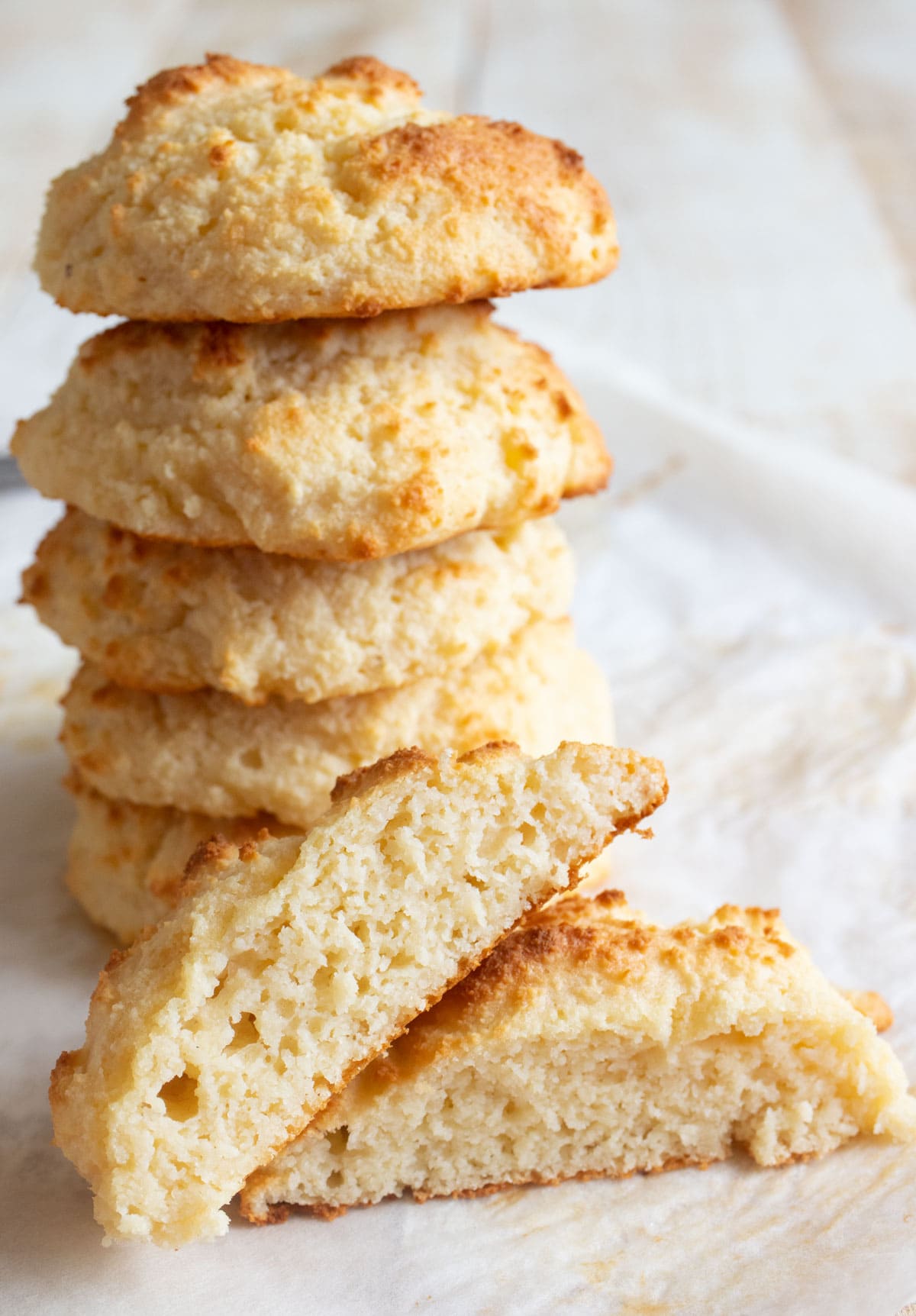 A stack of protein biscuits and a halved biscuit showing the fluffy inside.