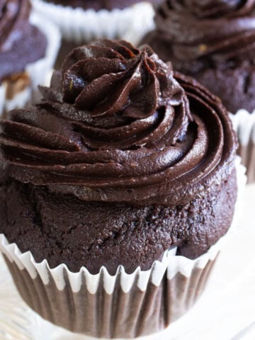 A keto chocolate cupcake topped with chocolate avocado frosting.