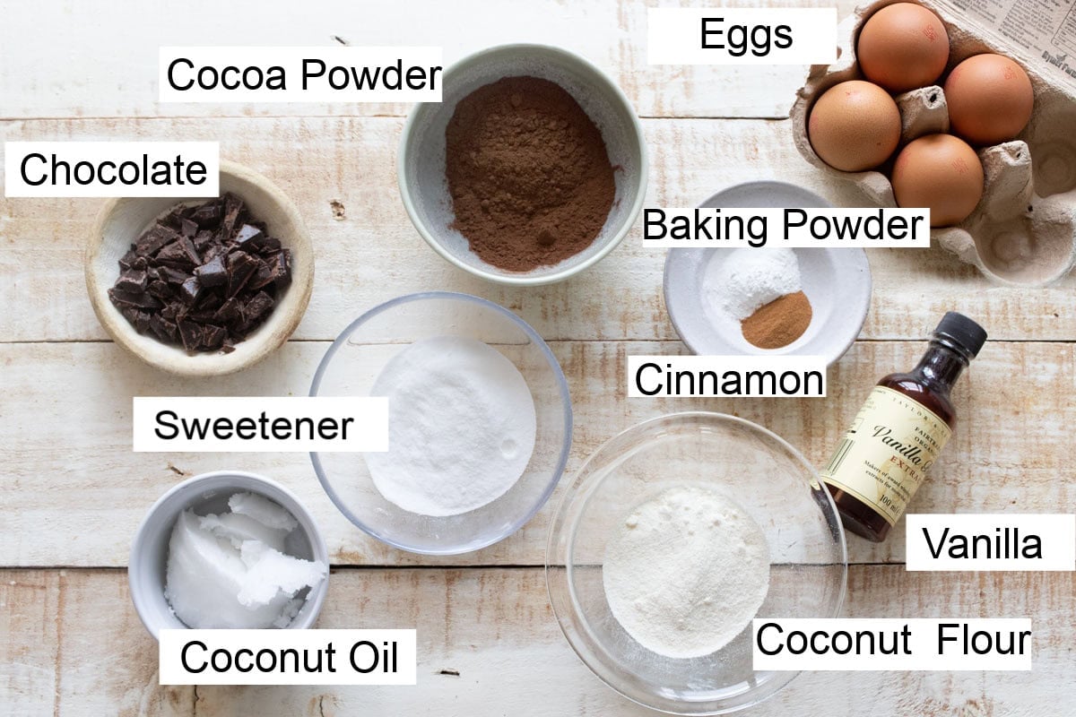 Ingredients to make sugar free chocolate cupcakes, measured into bowls and labelled.