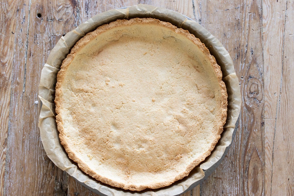 The baked and browned tart crust.