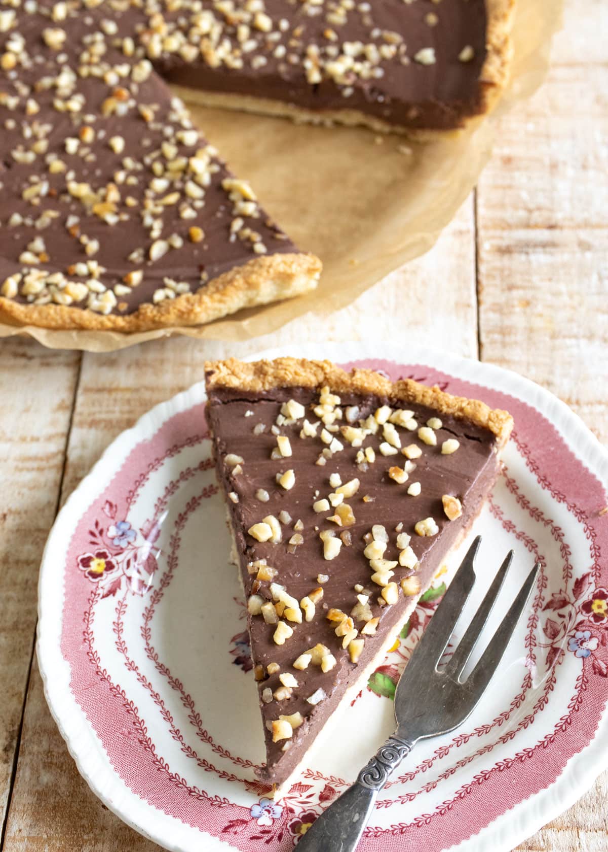 A slice of chocolate tart on a plate.