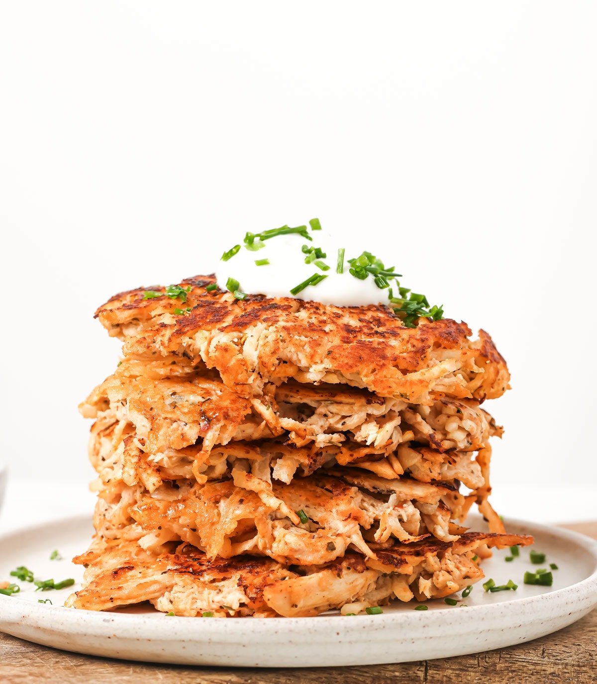 A stack of chicken fritters on a plate.