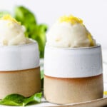 Sugar free lemon sorbet in ceramic bowl, topped with lemon zest.
