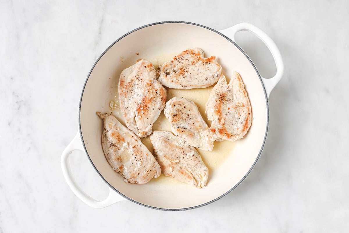 Frying chicken fillets in a pan.