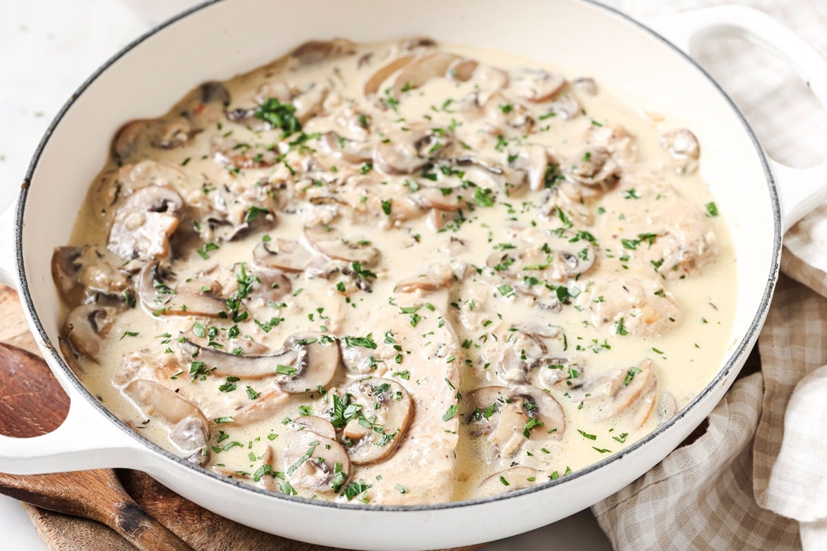 Adding the cream and butter to the mushroom chicken.