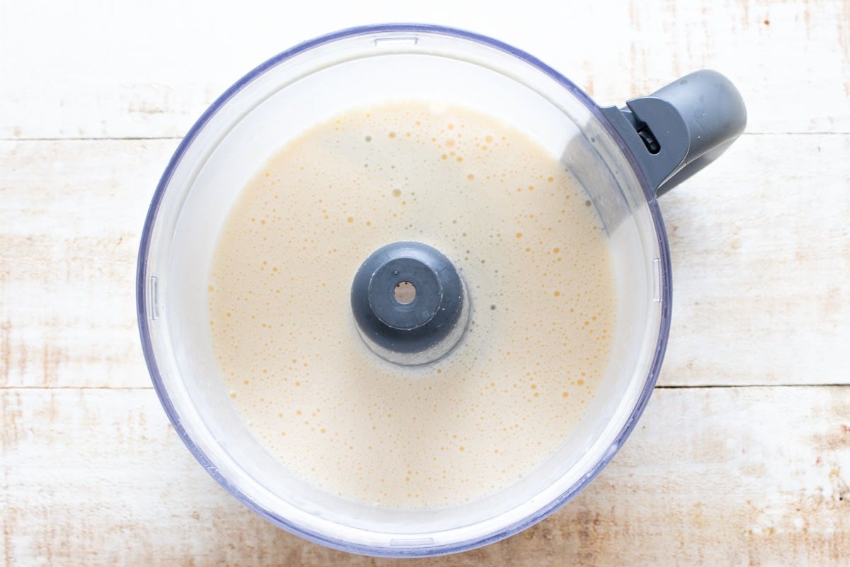 Mixed eggs and cottage cheese in a blender bowl.