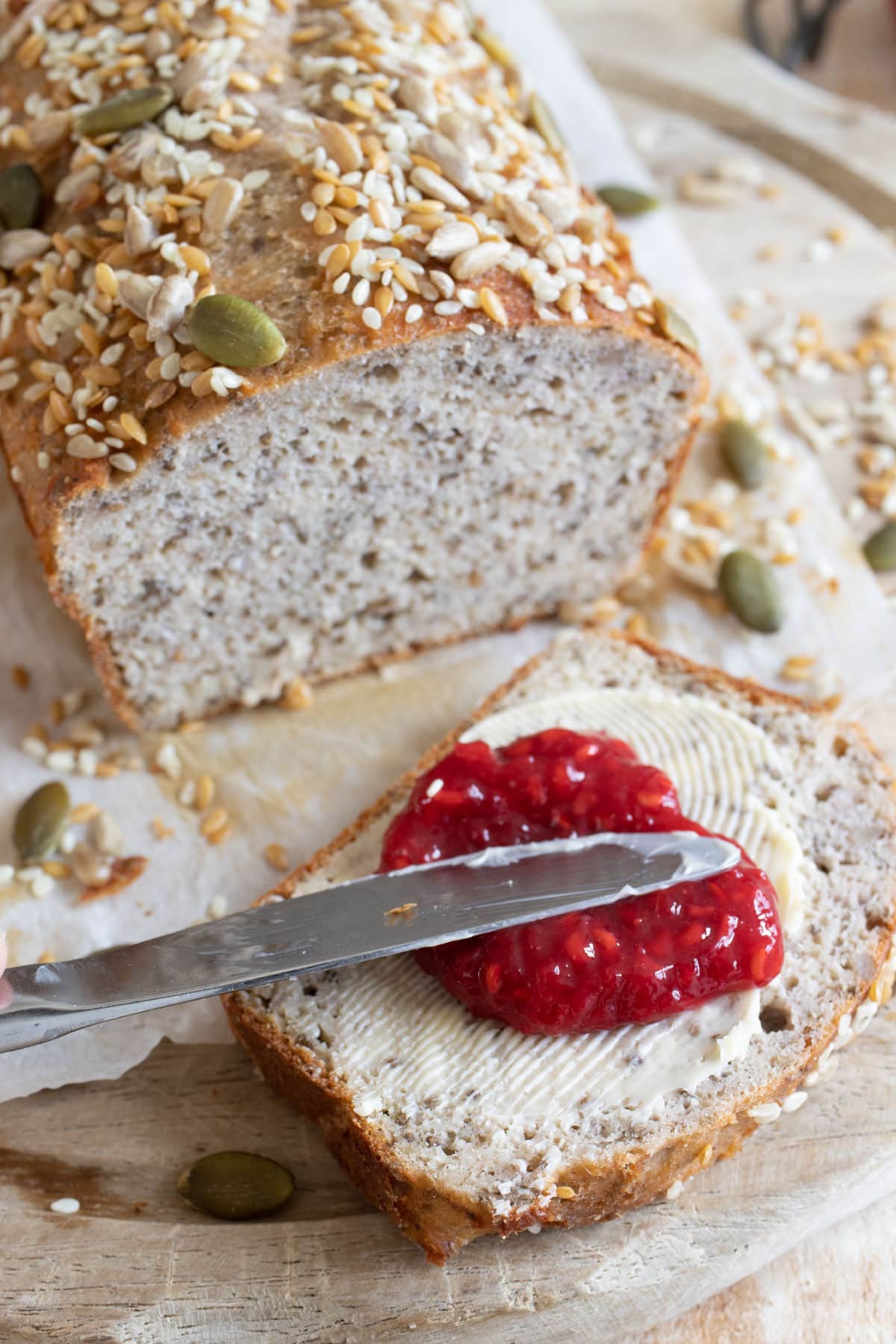 A slice of cottage cheese bread spread with butter and jam.