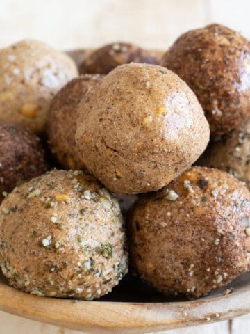 Keto protein balls, some rolled in crushed pumpkin seeds and cinnamon.