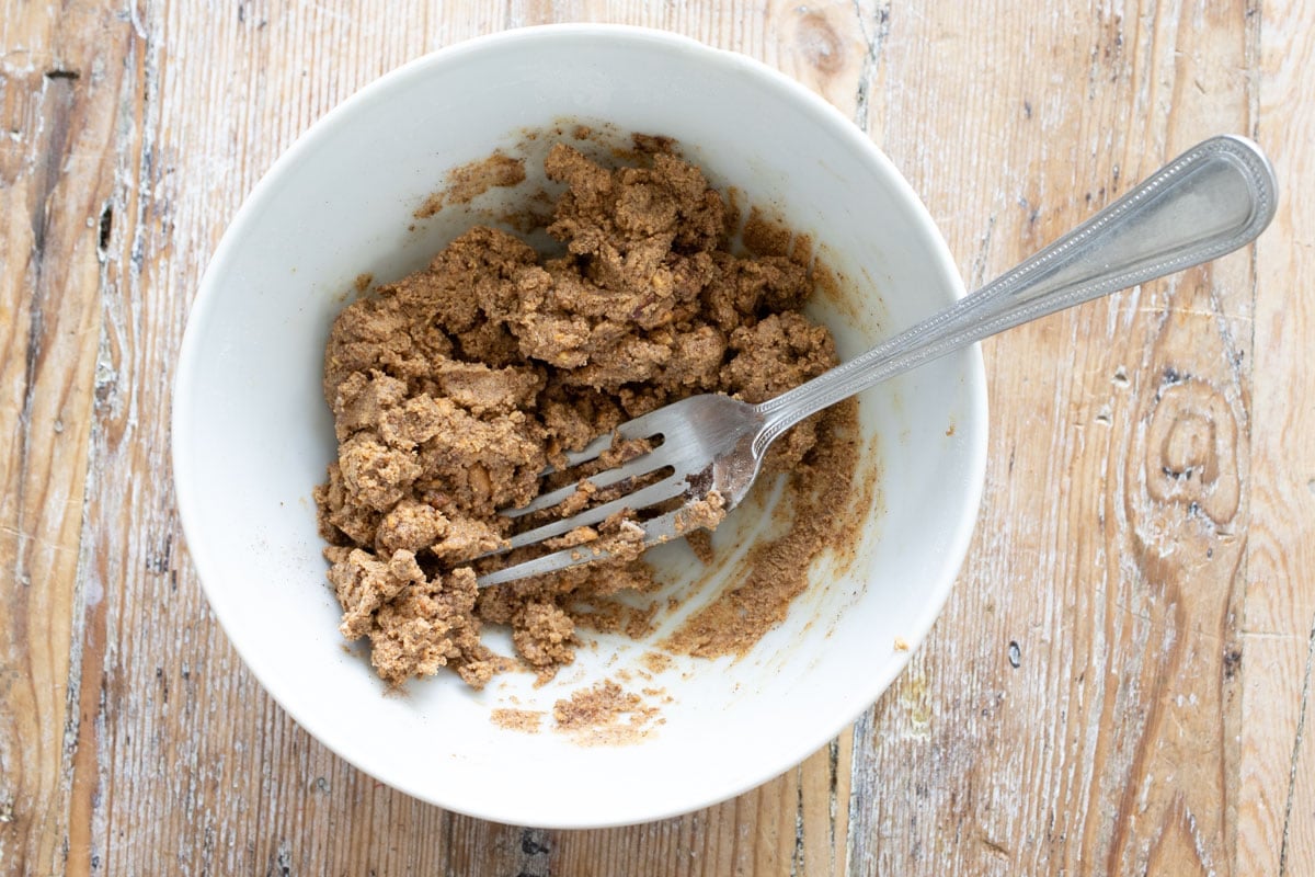 Crumbly dough in a bowl and a fork.