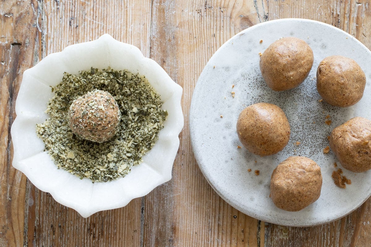 Rolling a ball in a bowl with crushed pumpkin seed .