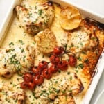 Tahini chicken in a baking dish after roasting in the oven.