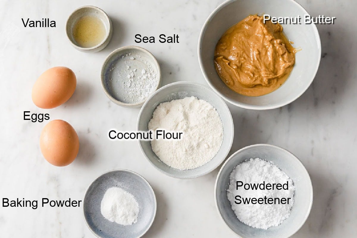 Ingredients to make coconut flour peanut butter cookies, measured into bowls and labelled.