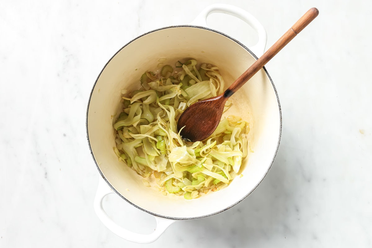 Sauteeing fennel, onion, celery and garlic in a soup pot.