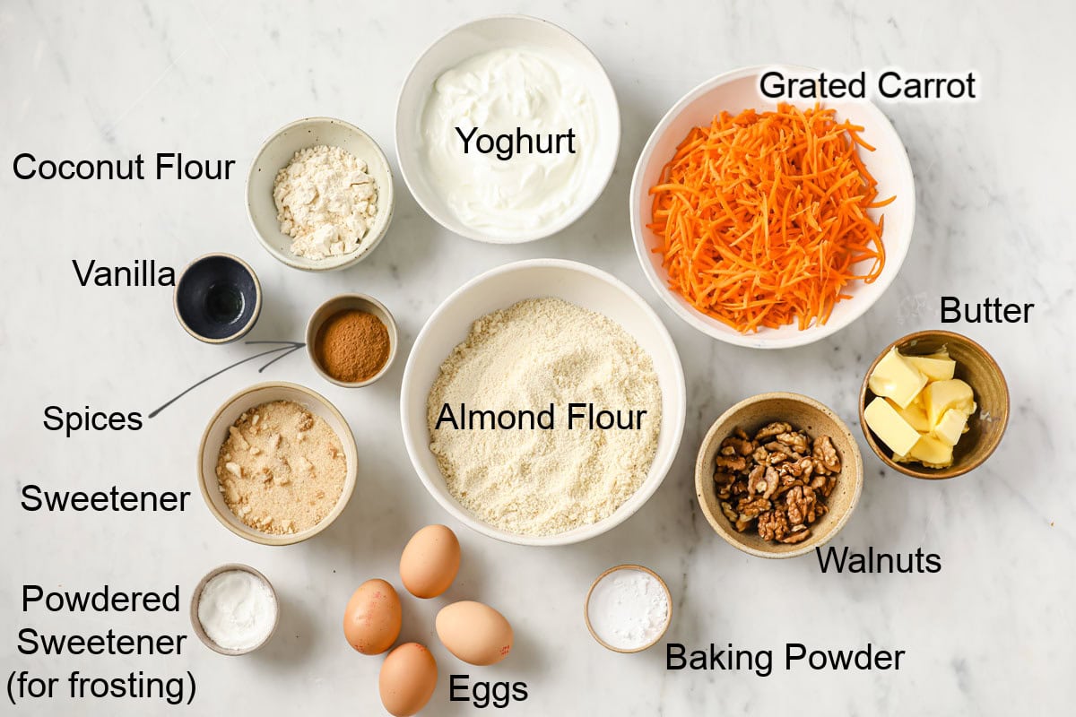 Ingredients to make sugar free carrot cake, measured into bowls and labeled.