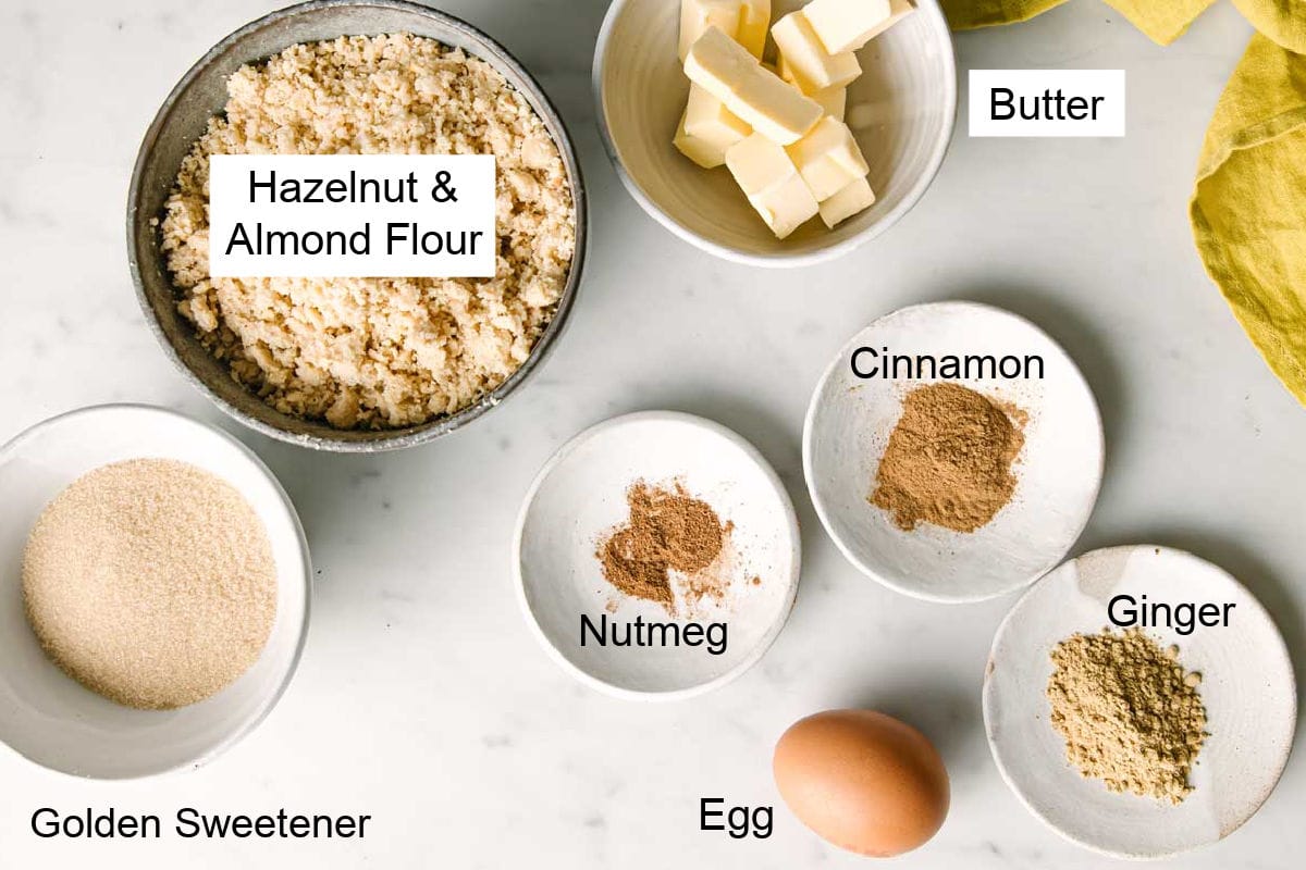 Ingredients to make keto gingerbread cookies, measured into bowls and labelled.