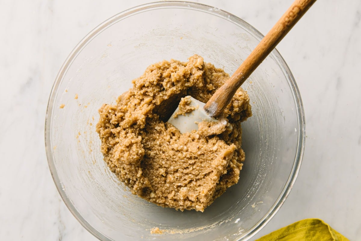 Gingerbread cookie dough in a bowl and a spatula.