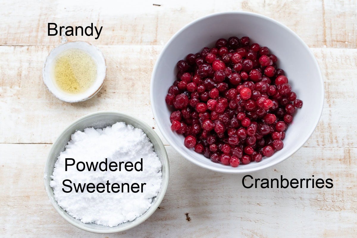 Ingredients to make sugar free cranberry sauce, measured into bowls and labelled.