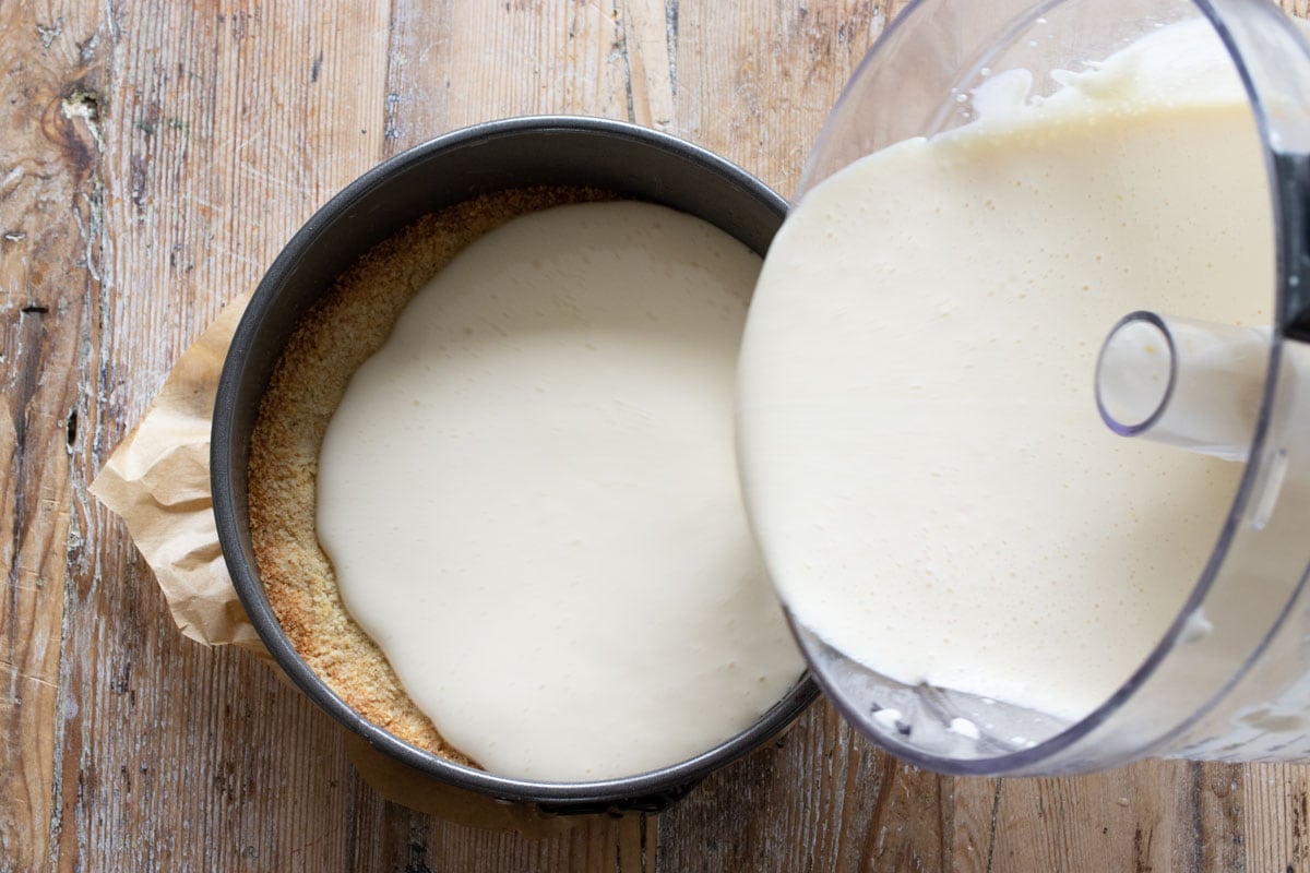 Pouring the filling on top of the baked crust.