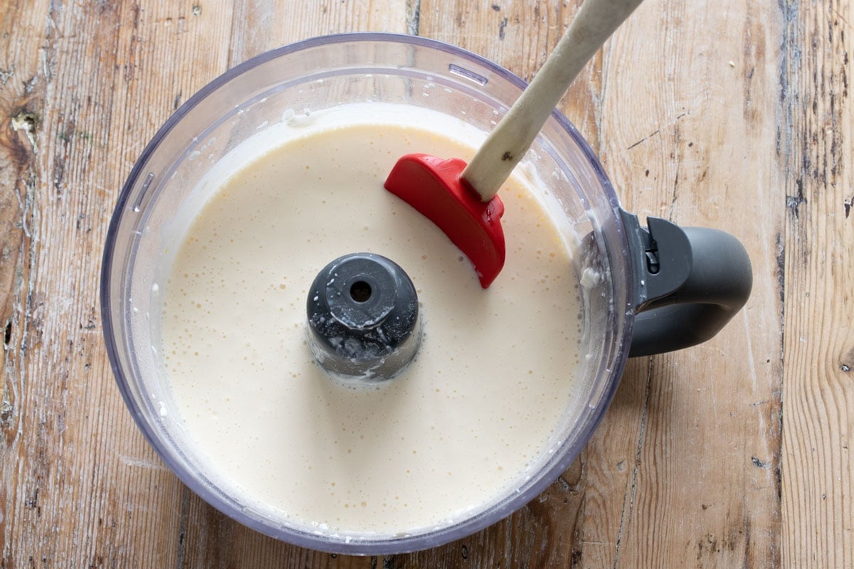 The cheesecake filling in a food protcessor bowl.