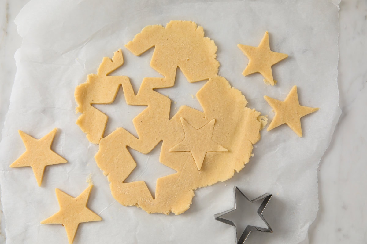 Cutting out stars from rolled out pastry.