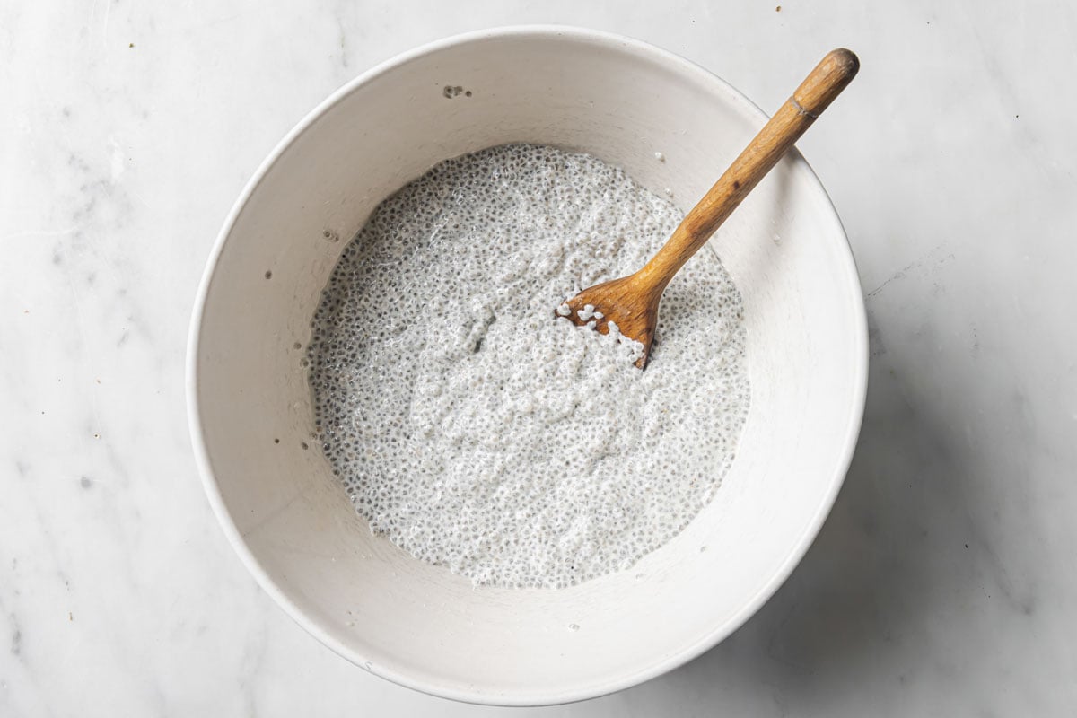 Stirring the yogurt into the chia pudding in a bowl.