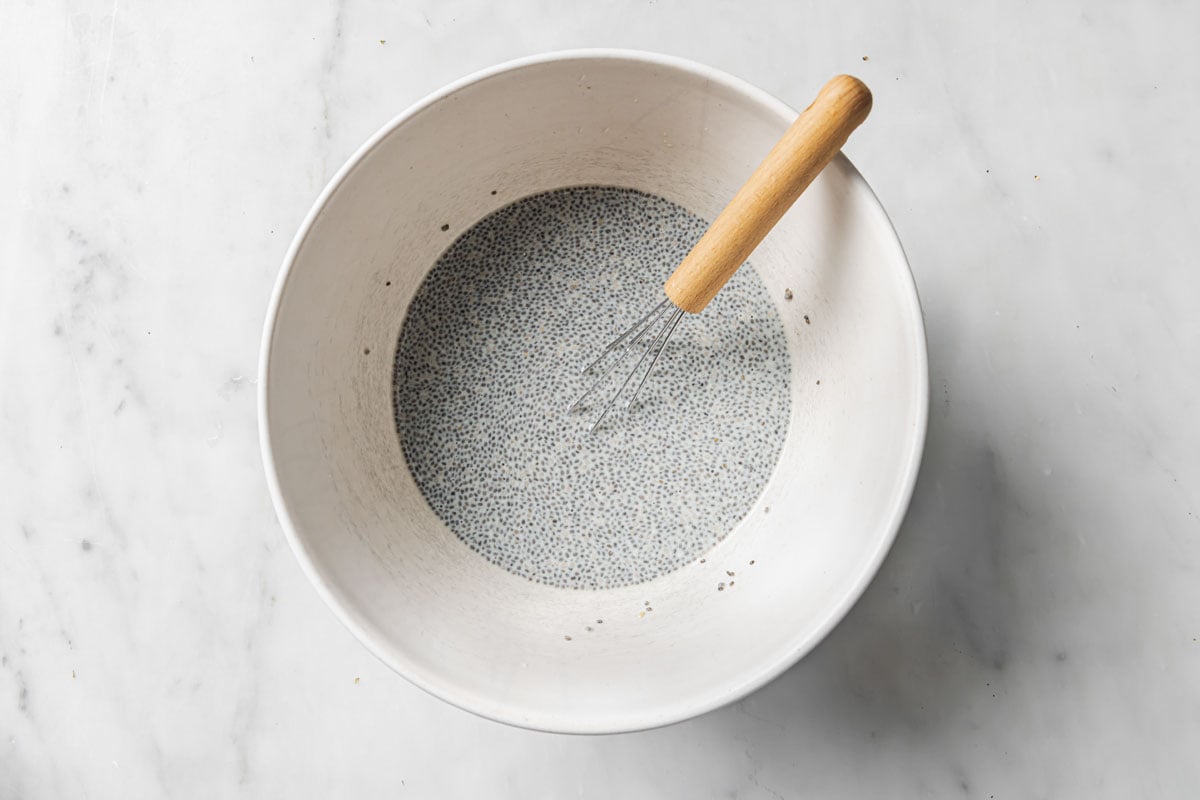 Chia seeds soaking up liquid in a bowl.