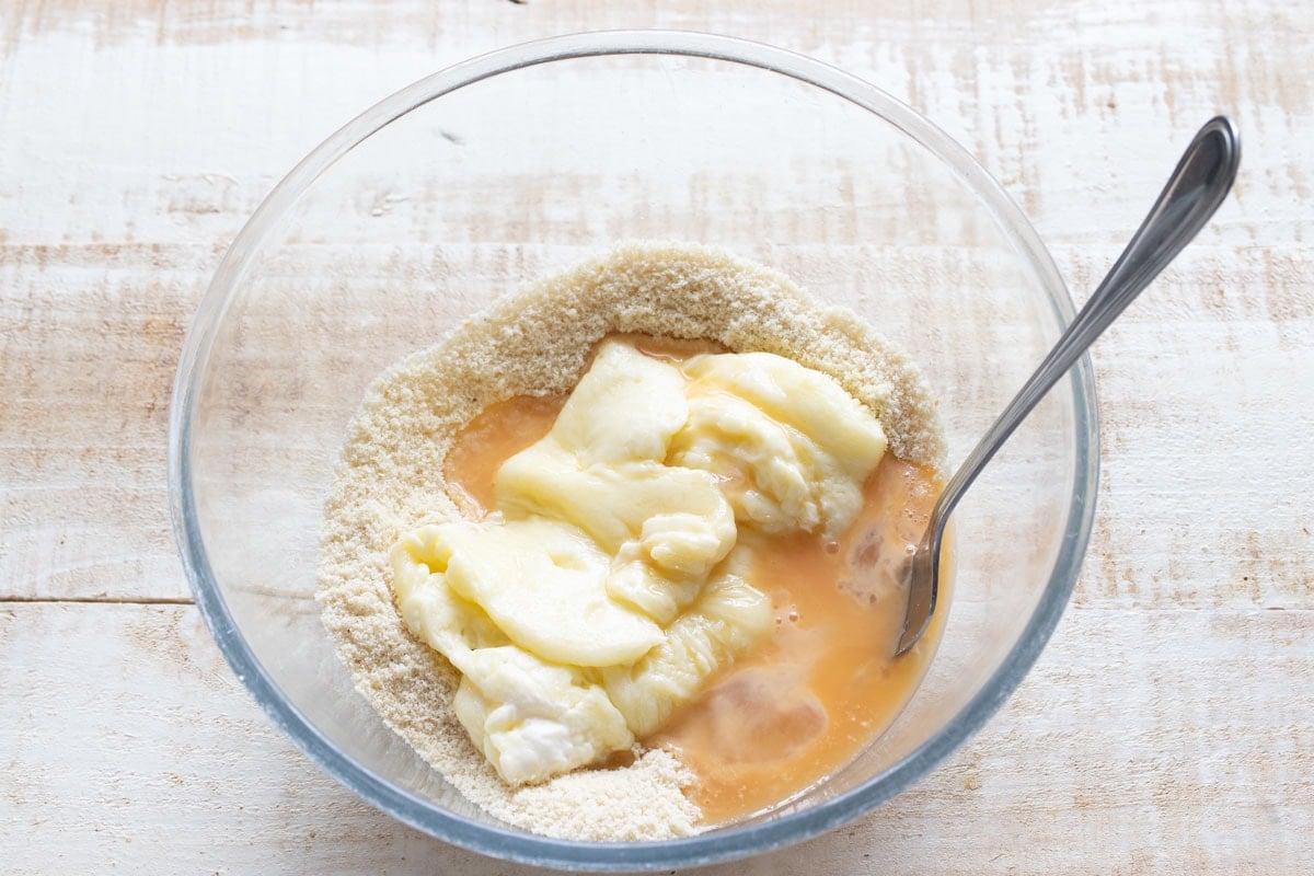 Almond flour mix, whisked egg and melted mozzarella in a bowl.