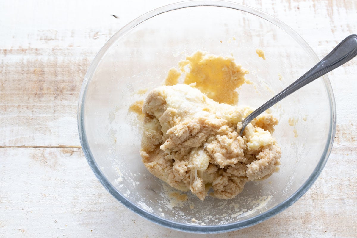 Mixing dough in a bowl with a fork.