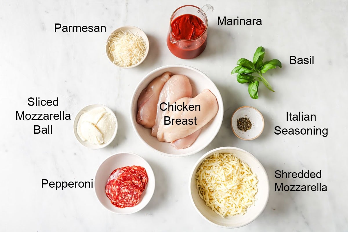 Ingredients to make pizza chicken, measured into bowls and labelled.