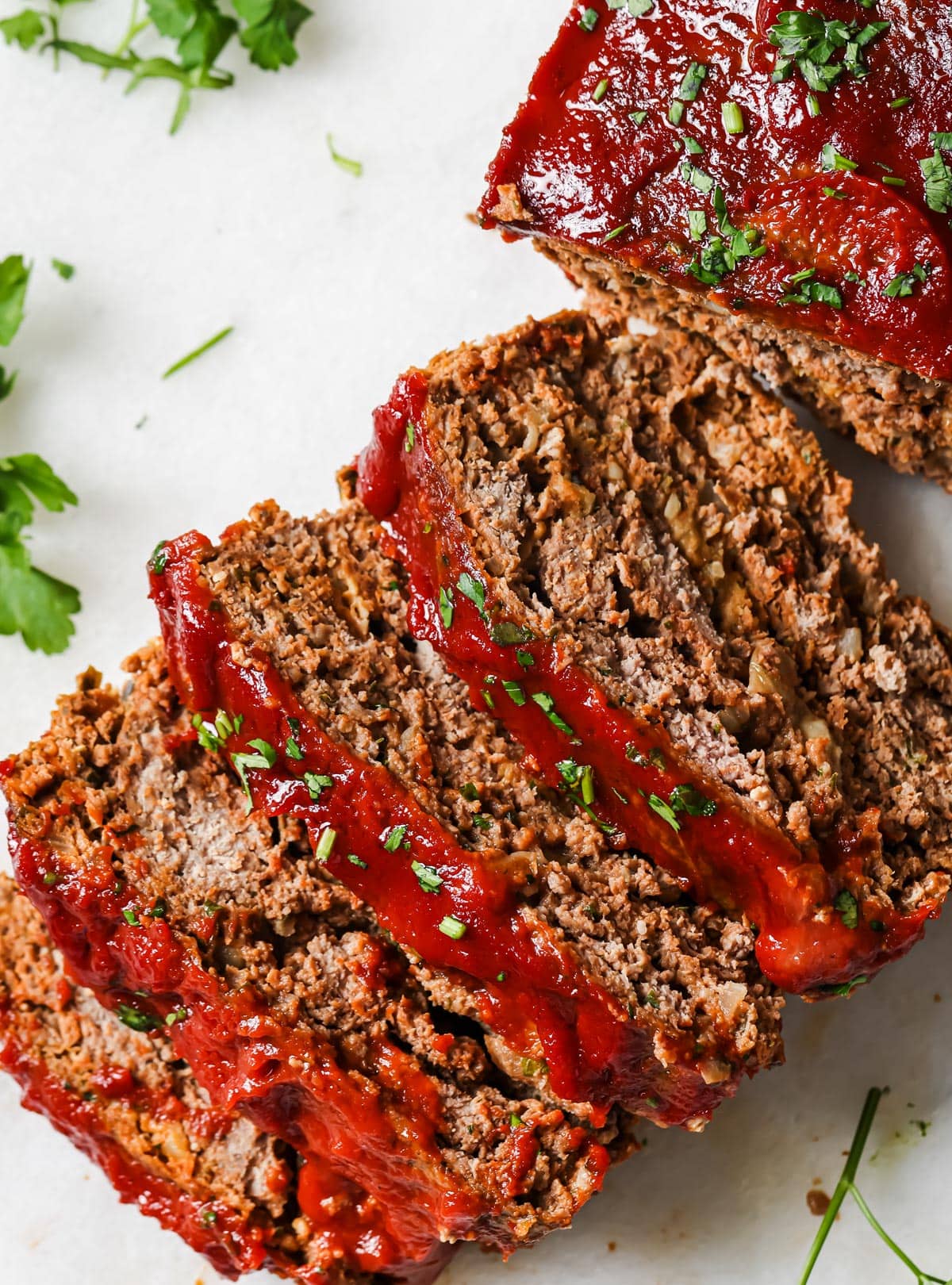 Sliced keto meatloaf on a board.