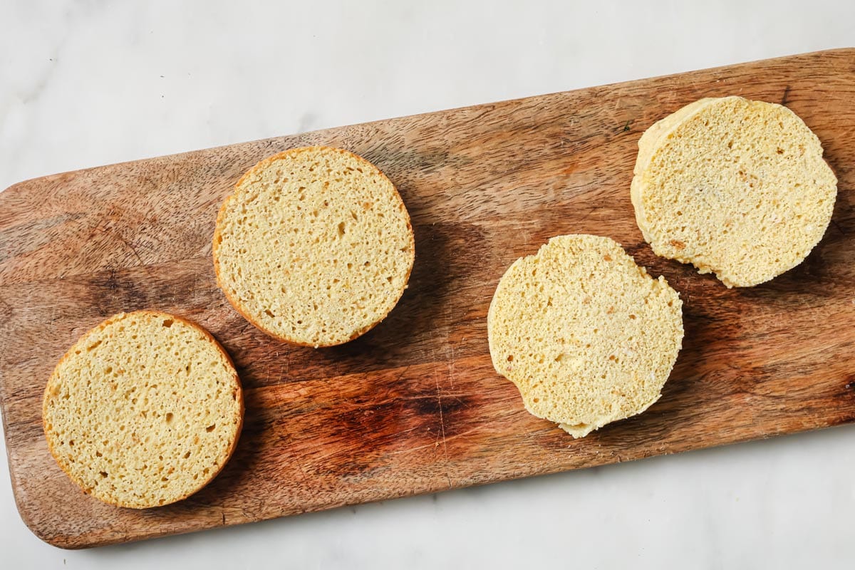 The sliced flax bread on a wooden board. Air fryer bread on the left, microwave on the right.