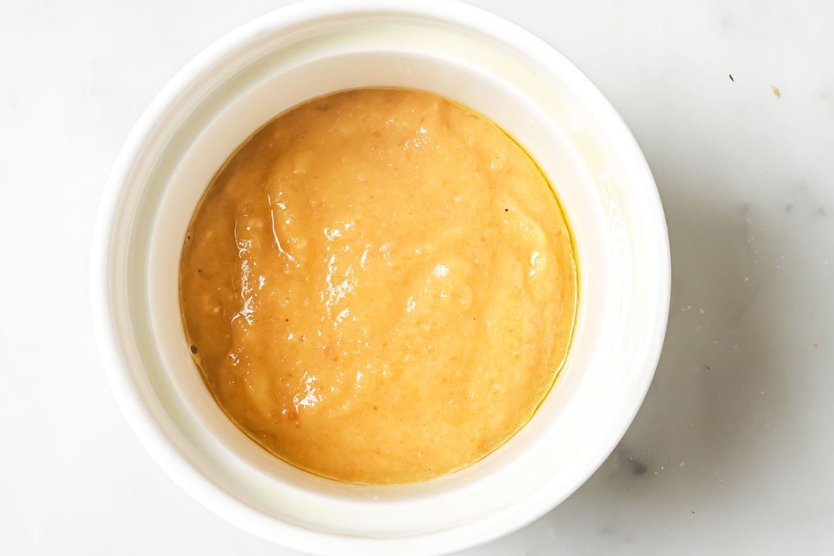 Keto mug bread batter in a greased ramekin.