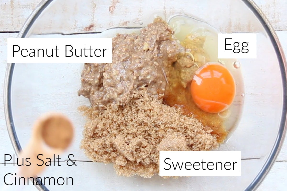 Ingredients to make peanut butter cookies in a glass bowl, all labelled.