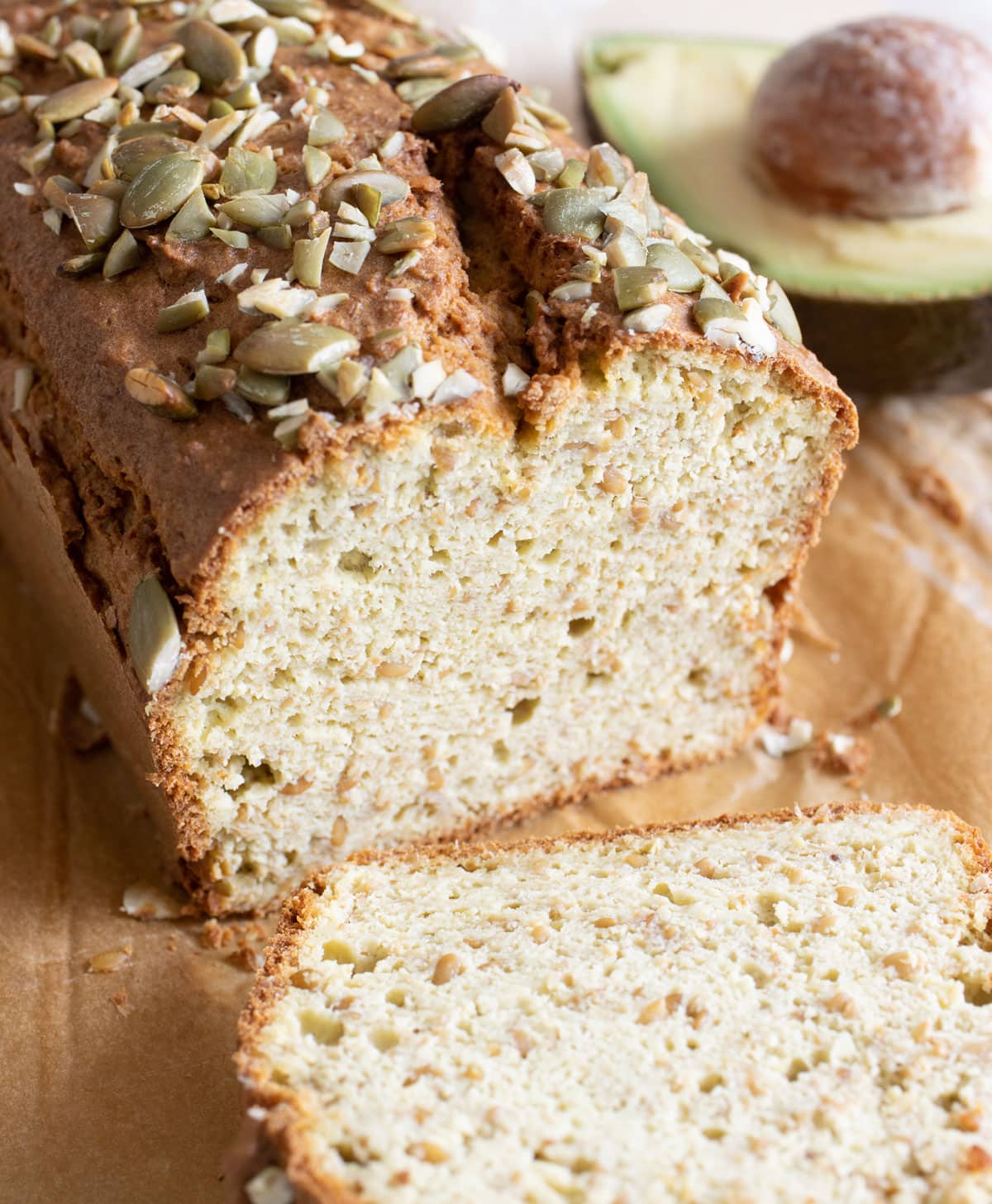 Avcado bread sliced open and an avocado half.