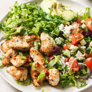 A serving of the Mediterranean chicken salad arranged on a plate.