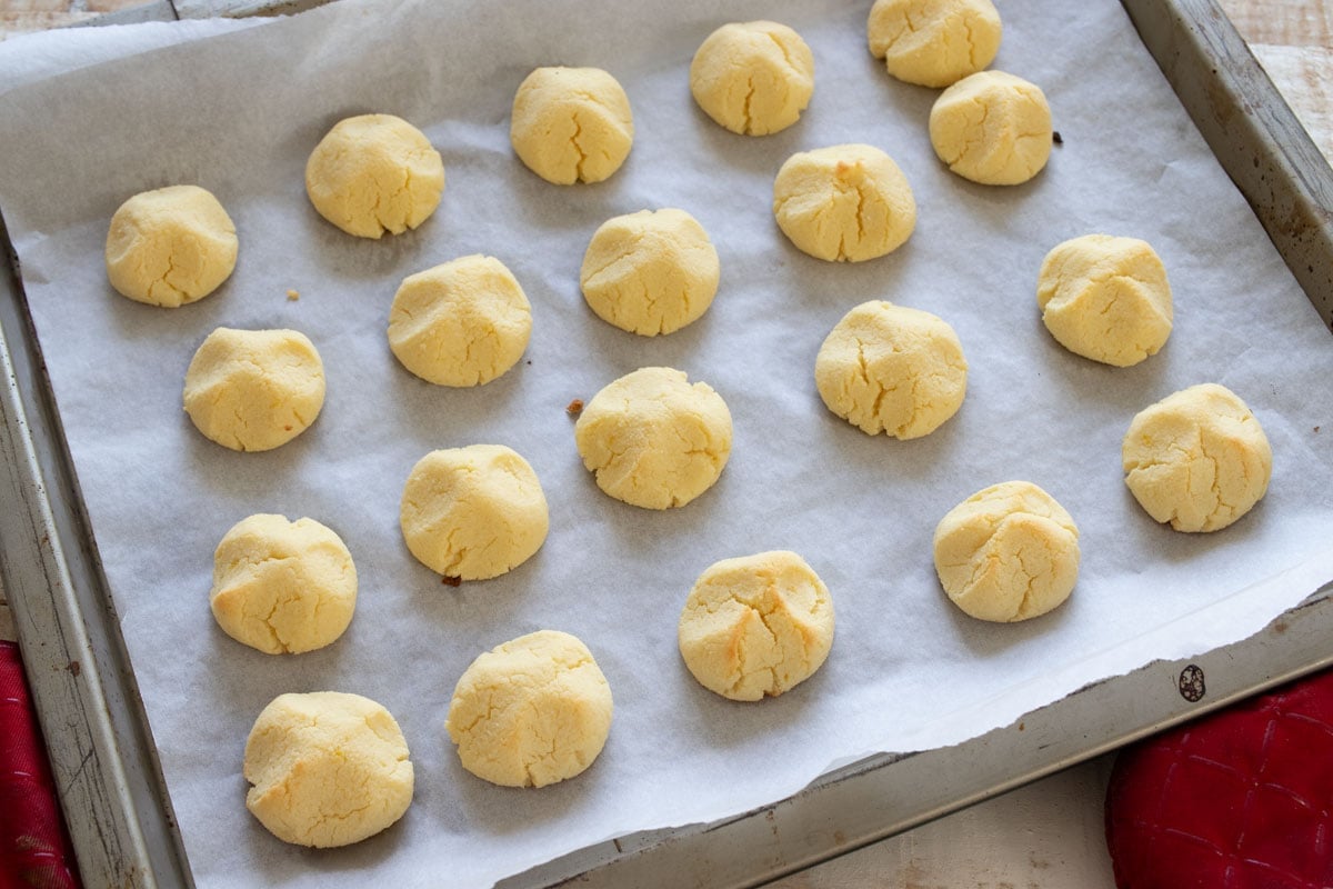 Baked cookies on a baking sheet lined with parchment paper.