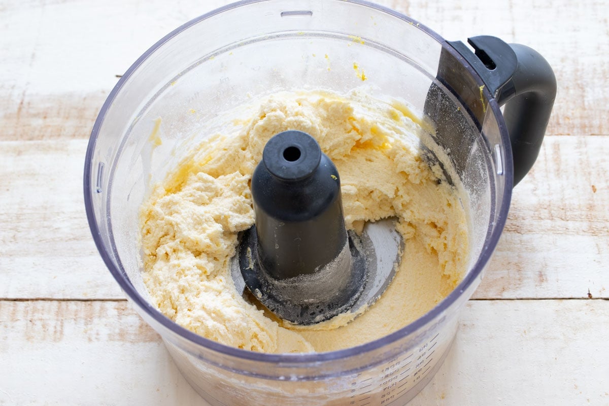 Cookie dough in a food processor bowl.