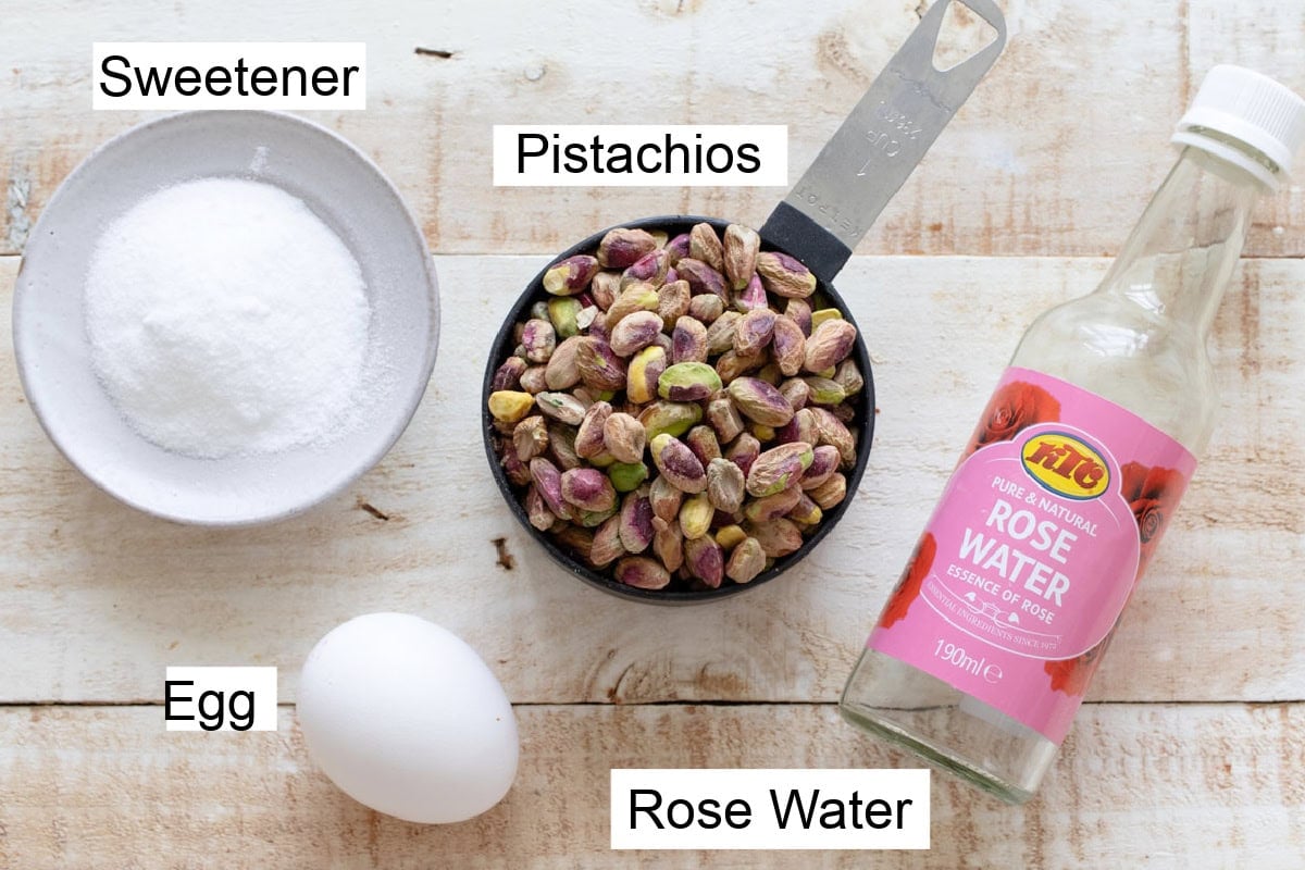 Ingredients to make keto pistachio cookies measured into bowls and labelled.