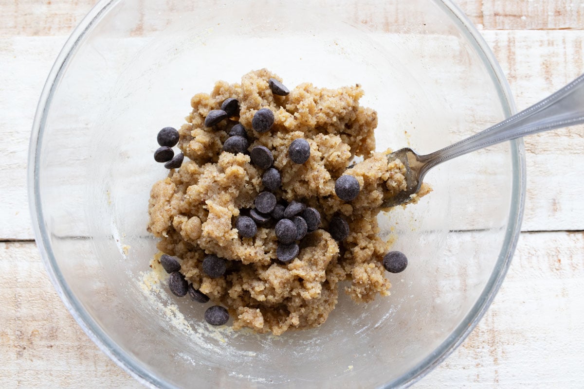 Chocolate chips in the bowl with the cookie dough.