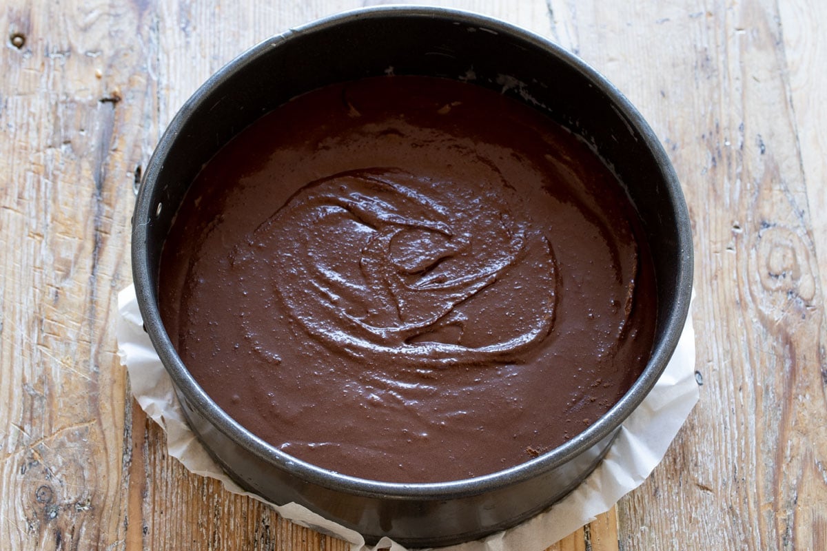 The chocolate cake batter filled into a lined springform.