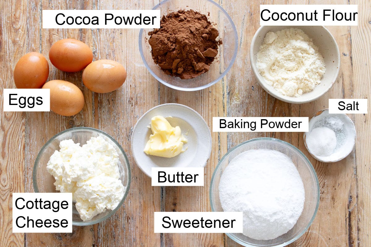 Ingredients to make a cottage cheese chocolate cake, measured into bowls and labelled.
