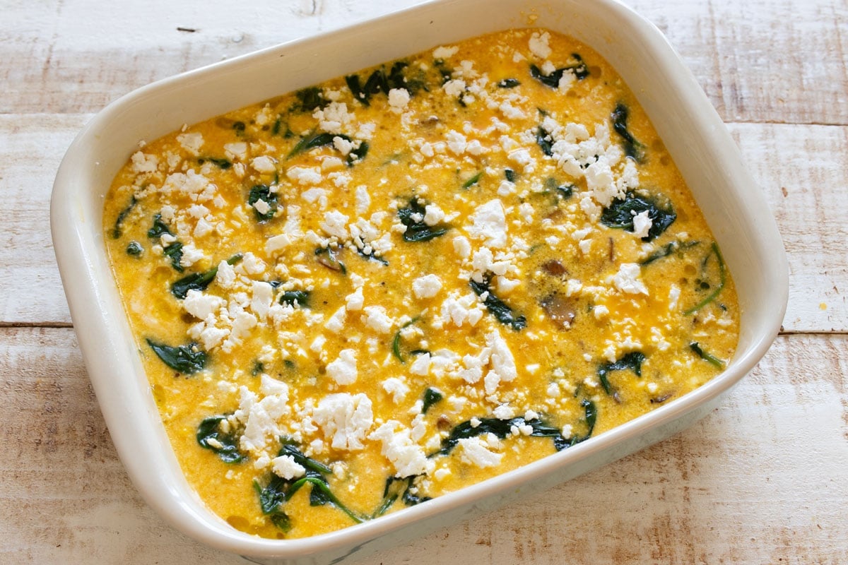 The egg bake topped with crumbled feta cheese before baking.