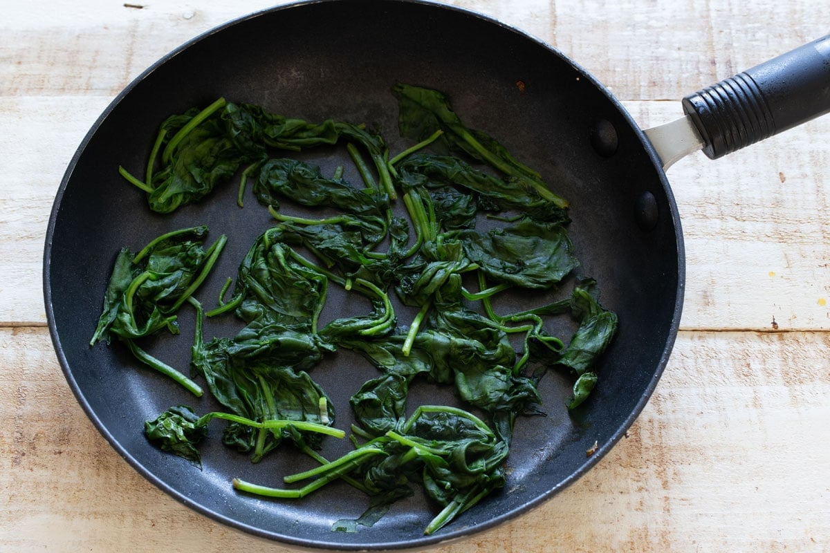 Sauteed spinach in a pan.