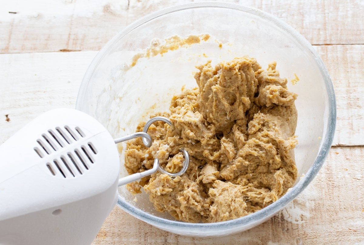 Mixing bread dough with an electric mixer and dough hooks.