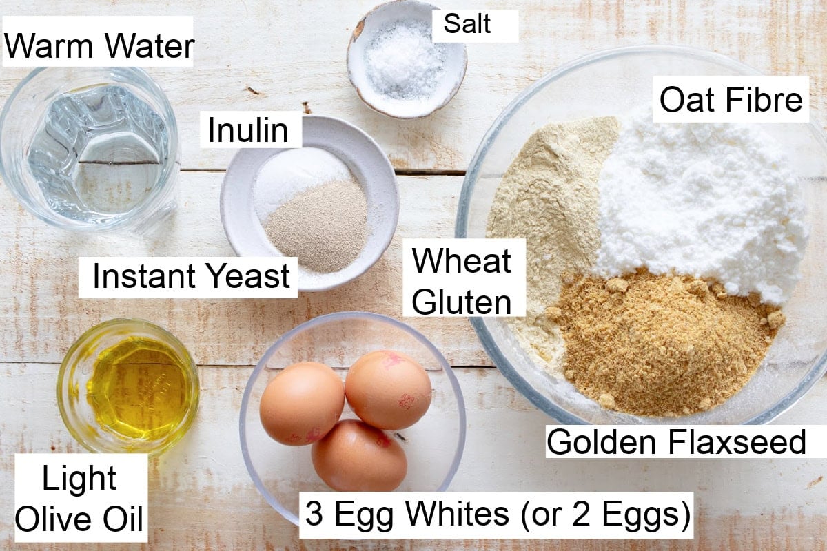 Ingredients to make a keto yeast bread, measured into bowls and labelled.