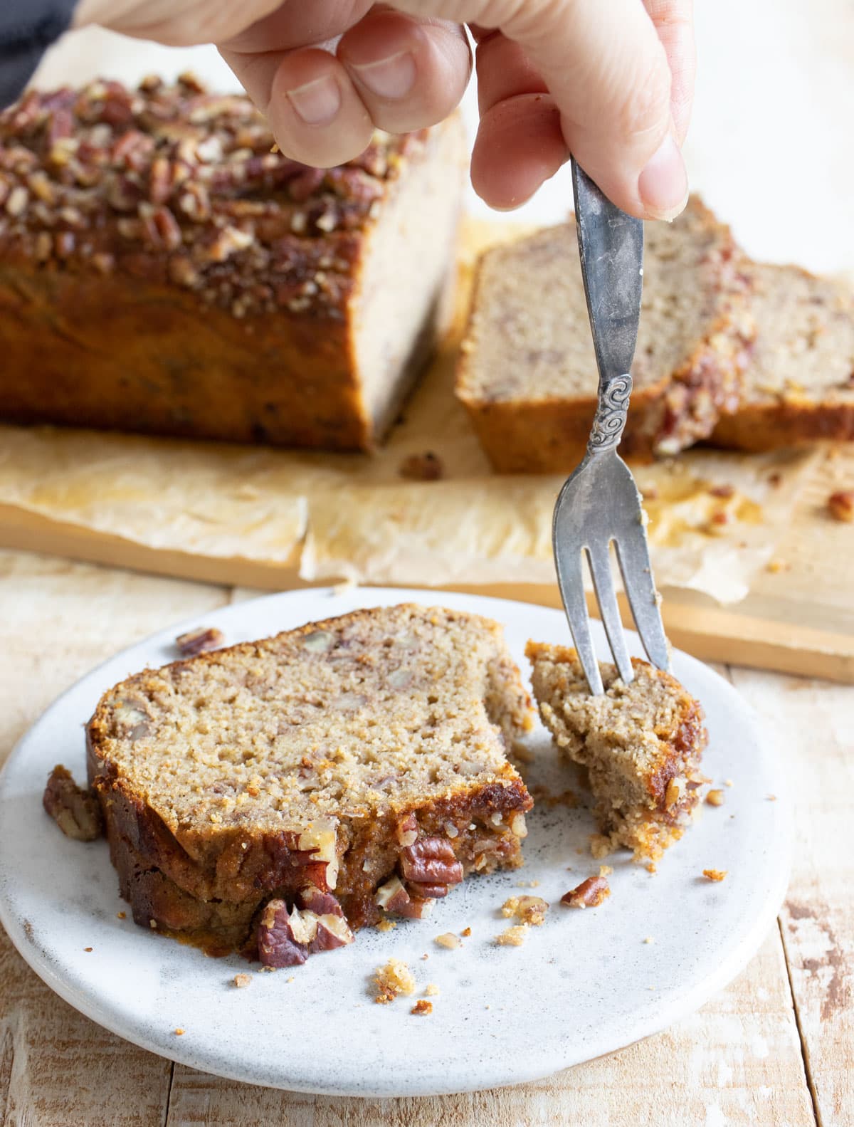 A slice of cottage cheese banana bread on a plate and a fork.