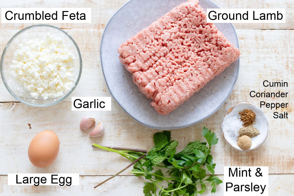 Ingredients to make greek style lamb meatballs with feta, garlic and fresh herbs, measured and labelled.